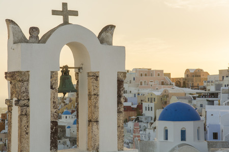 Traditional church belfry at sunset, Oia, Santorini, Greeceの写真素材