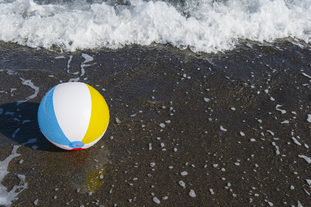 Colorful ball on the seashore. Focus on ballの写真素材