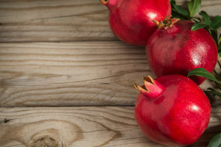 Close up of some red juicy pomegranate fruits with leaves. Selective focusの写真素材