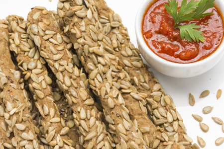 Breadsticks with sunflower seeds, and red sauce