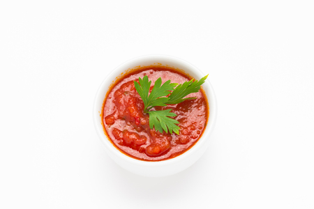 Red dip sauce with parsley leaves, isolated on white backgroundの写真素材