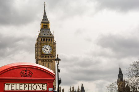 Red telephone booth front of Big Ben on a cloudy day, London, Englandの写真素材