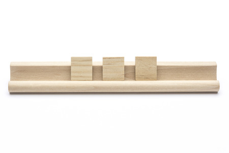Three blank  tiles on a wooden rack, on white backgroundの写真素材