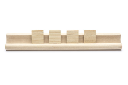 Four blank  tiles on a wooden rack, on white backgroundの写真素材