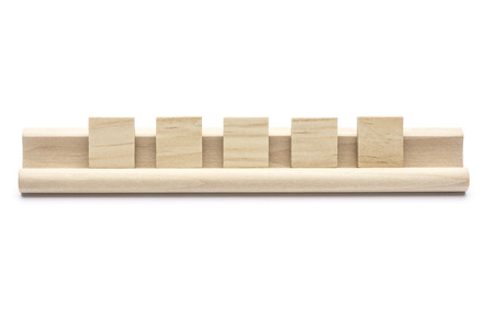 Five blank  tiles on a wooden rack, on white backgroundの写真素材
