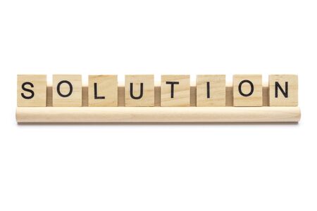 Word ''solution'' on  wooden letters on a rack, isolated on white background.の写真素材