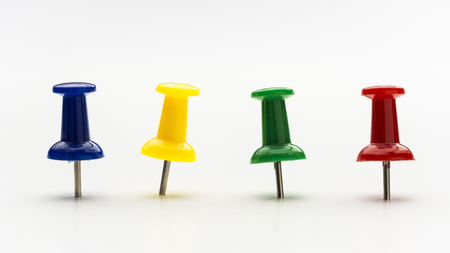Four colored push pins in a row on white backgroundの写真素材