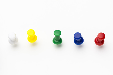 Five colored push pins on white backgroundの写真素材
