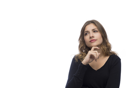 Beautiful young woman is thinking, isolated on white backgroundの写真素材