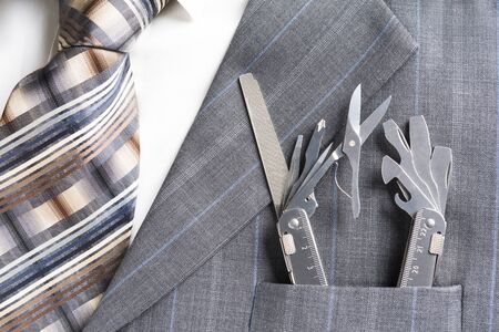 Multitool in pocket of businessman in a support/service conceptの写真素材