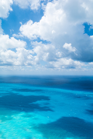 Blue sky with white clouds over turquoise seaの写真素材