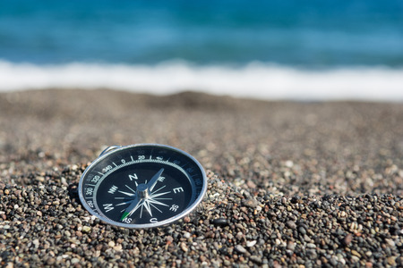 Navigational compass on the beach, Close up, Selective focusの写真素材