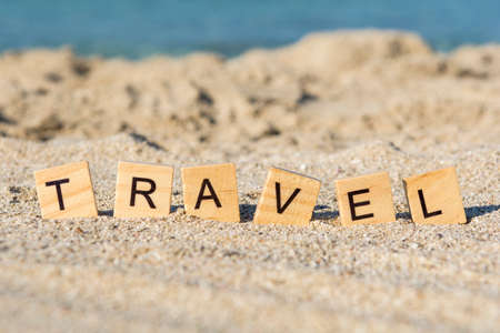 Word travel on the beach, close upの写真素材