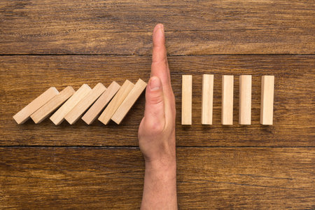 Stopping the domino effect conceptの写真素材