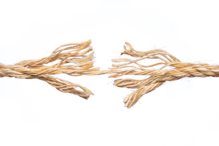 Frayed rope ready to break isolated on white backgroundの写真素材