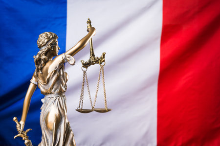 The statue of justice Themis or Justitia, the blindfolded goddess of justice against the flag of France, as a legal conceptの写真素材