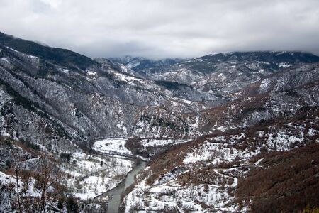 Winter landscape of river passing through mountains
