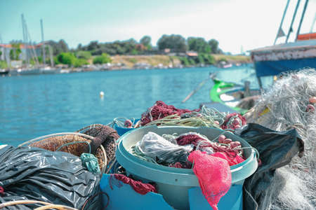 Buckets filled up with fishing nests and equipment in a greek harborの写真素材