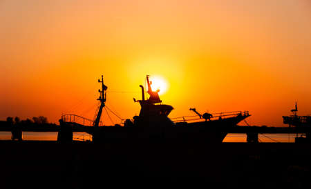 boat silhouette with sunsetの写真素材