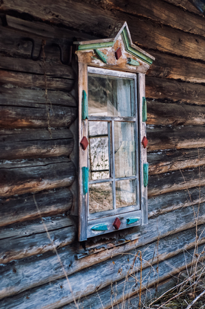 old window frames in an abandoned wooden house with broken glassの写真素材