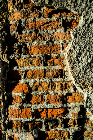 Plaster peeled off from the old walls and became visible brickworkの写真素材