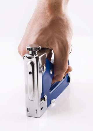 Staple gun in man's arm over white backgroundの写真素材