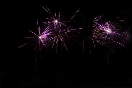 Bright fireworks at night in the black sky useful as background