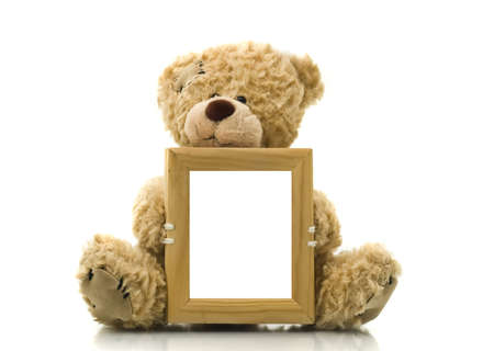 Cute bear holding empty frame for picture or photo over whiteの写真素材