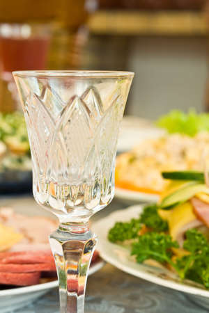 Banquet in the restaurant - crystal wineglass. Focused on one dish (shallow DOF)の写真素材