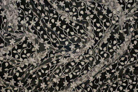 Beautiful lacy tissue over black background