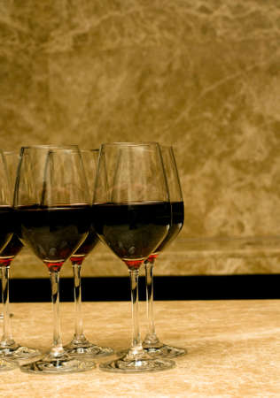 Glasses with red wine on marble in the barの写真素材