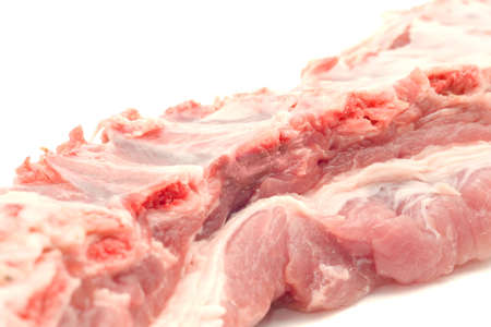 Uncooked pork ribs and meat isolated over whiteの写真素材
