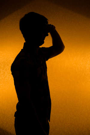 Looking forward. Back lit silhouette of confident man in the darknessの写真素材