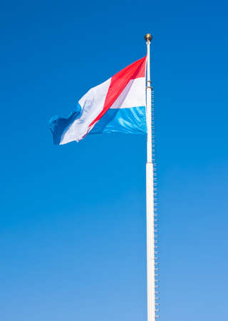 Flag of Luxembourg over blue sky. This photo is taken in Luxembourgの写真素材