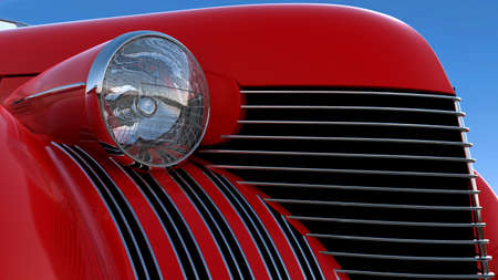 Headlight and engine jacket of red retro car over blue sky backgroundの写真素材