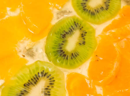 Tasty Fruit background. Sliced kiwi and orange segmentsの写真素材