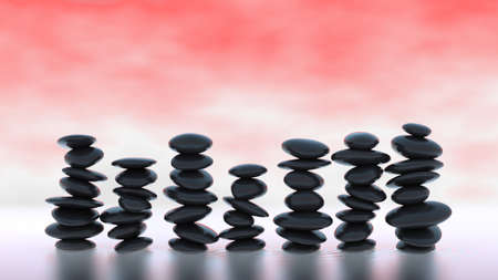 Black Pebble stacks on over red misty backgroundの写真素材