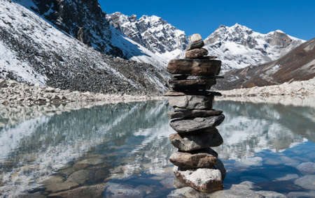 stability: Stone stack and Sacred Lake near Gokyo in Himalayasの写真素材