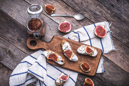 Tasty Bruschetta with jam and figs on napkin in rustic style. Breakfast, lunch food photoの写真素材