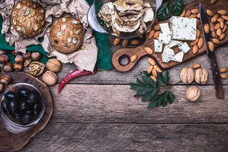 Lunch olives, nuts and  sheep cheese with bread in rustic styleの写真素材