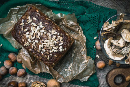 Closeup of bread with seeds, nuts and mushrooms in rustic styleの写真素材