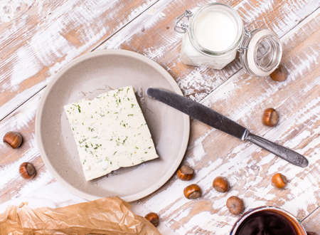 cheese with dill and joghurt for breakfast on wooden table in rustic styleの写真素材