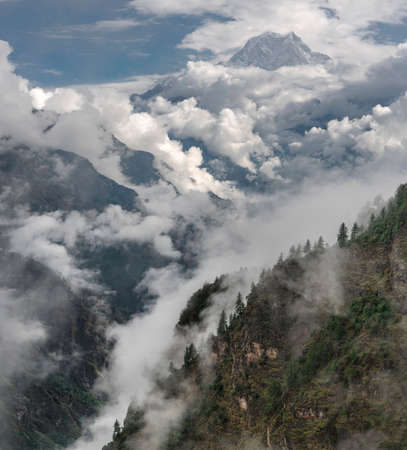 Nilgiri summit and cloudy Himalayas. Monsoon time in Nepal