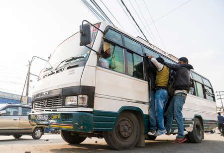 Overcrowded bus with people gripping its doors. Fuel crisis in Nepal. Captured in Nepal in winter...