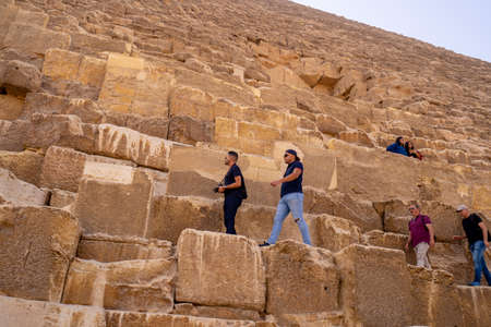 Tourists climbing  Pyramid of Giza near Cairo. Captured in Egypt. Autumn 2018のeditorial素材