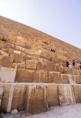 Tourists climbing  Pyramid of Giza near Cairo. Captured in Egypt. Autumn 2018のeditorial素材