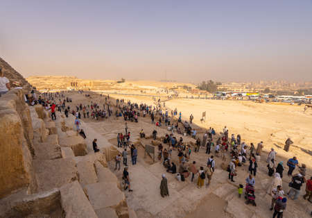 Tourists around  Pyramids of Giza and Cairo  in the background. Captured in Egypt. Autumn 2018のeditorial素材