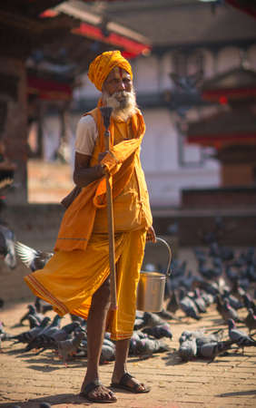 Hindu sadhu man and doves on Durbar square in Kathmandu, Nepal, October 2013のeditorial素材