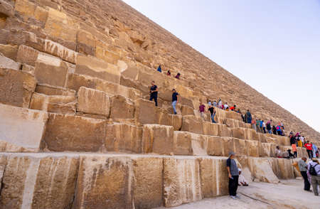 Tourists climbing  Pyramid of Giza near Cairo. Captured in Egypt. Autumn 2018のeditorial素材