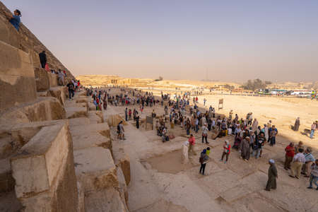 Tourists around  Pyramids of Giza and Cairo  in the background. Captured in Egypt. Autumn 2018のeditorial素材